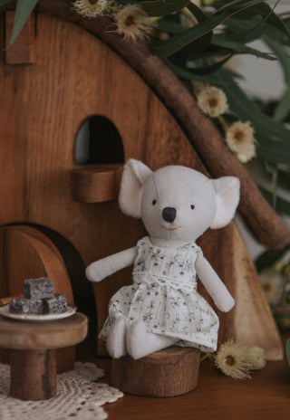 Miniature Rugaroo Koala doll enjoying pretend play with dollhouse-sized plat and lamingtons — adorable Aussie soft toys for imaginative storytelling.