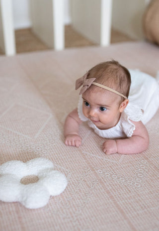 A Neutral and Soft Pink luxe foam padded baby playmat that is double sided, earth-friendly, waterproof and non-toxic.