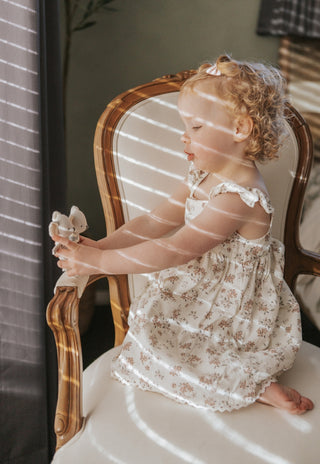 Child playing with a pair of miniature Rugaroo Koala dolls, cuddling the soft linen Aussie toys and creating her own adventure scenes.