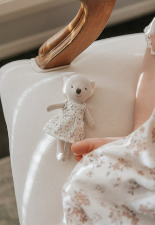 Little girl with Rugaroo Koala plush doll and matching floral dresses, soft ears, and iconic Australian character design for kids’ play.