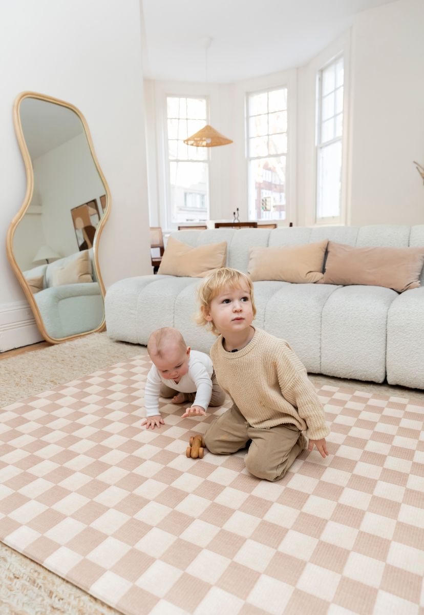 Neutral checkered double-sided foam padded play mat that looks like rug and is waterproof - latte colour