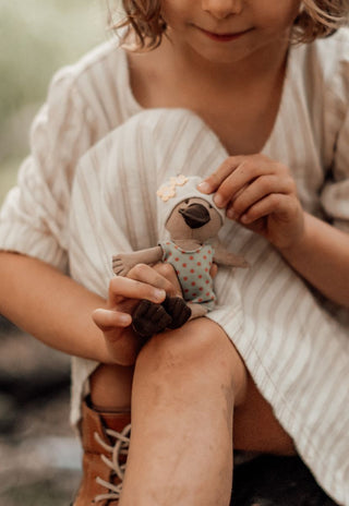 a girl holding Nora the plush Rugaroo Platypus Billabong Swimmer doll