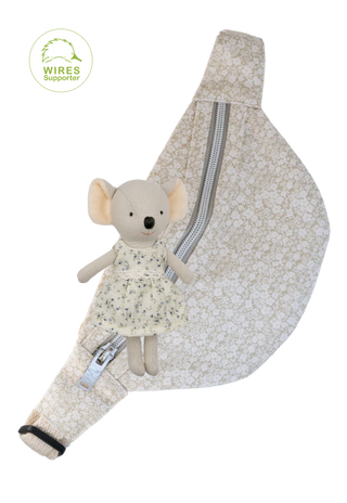 Rugaroo floral pouch bag with sage and white blossom print, zippered front, and adjustable strap designed to carry miniature Aussie dolls securely for adventures. Koala plush doll above the bum bag.