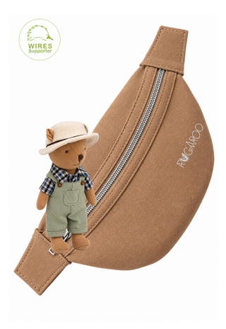 Wazza the Cockie Wombat plush doll, an Aussie farmer character, with a tan canvas Rugaroo kids bum bag with silver zip and adjustable strap