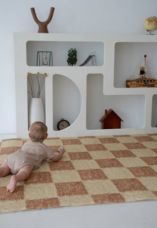 Baby crawling on large checkered Phoenix non toxic foam baby play mat by Rugabub.