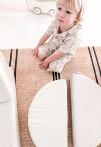 Foam padded baby play mat with black stripes that looks like a rug