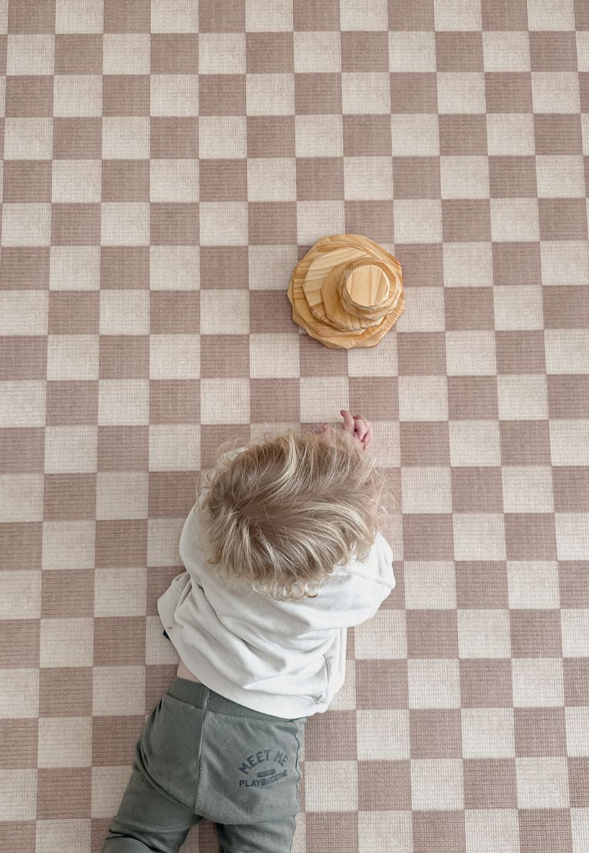 round checkered foam padded baby play mat in latte colour that looks like rug