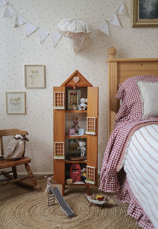 Aussie miniature dolls styled on wooden shelf in nursery
