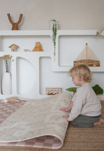 Neutral checkered double-sided foam padded play mat that looks like rug and is waterproof
