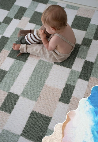 Baby sitting on Rugabub Retro Phoenix green checkered non toxic foam baby play mat.