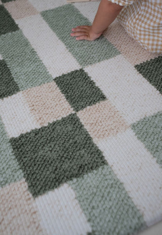 Close up texture of Rugabub green checkered non toxic foam baby play mat.