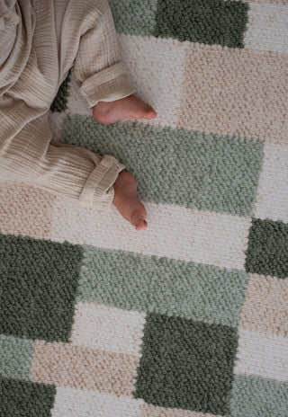 Baby feet on Rugabub green checkered non toxic foam baby play mat.