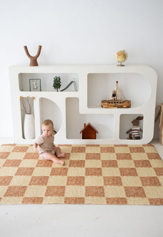 Rugabub Phoenix checkered non toxic foam baby play mat styled in a minimalist nursery.
