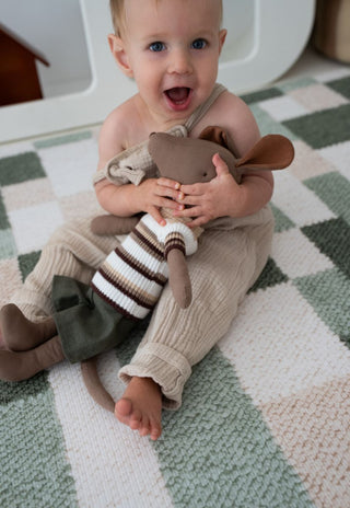 Baby playing on large Rugabub green checkered non toxic foam baby play mat in nursery.