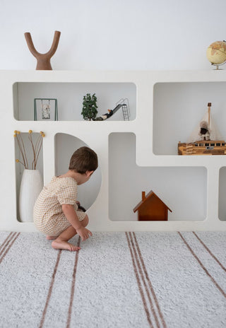 Large Rugabub Cala neutral striped baby play mat styled in modern nursery.