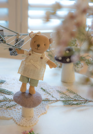 Marg the Wombat hanging the washing on the Rugaroo Backyard Hoist miniature rotary clothesline, standing on a mushroom