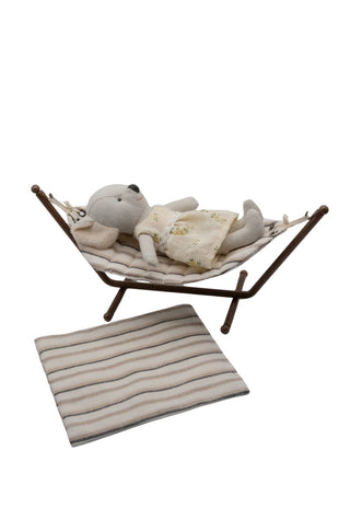 Hammock with koala doll and a blanket on a white background