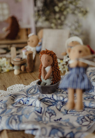 A styled tabletop display featuring Rugaroo's echidna doll, Col, sitting in a tiny tinnie boat.