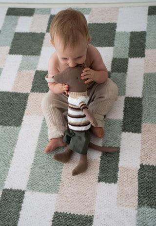 Modern nursery with Rugabub green checkered non toxic foam baby play mat and baby playing.