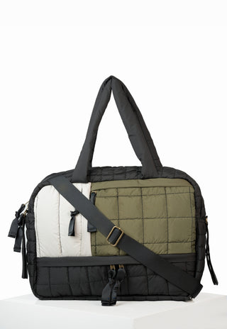 Multicolored fashion baby bag with black strap on a white background