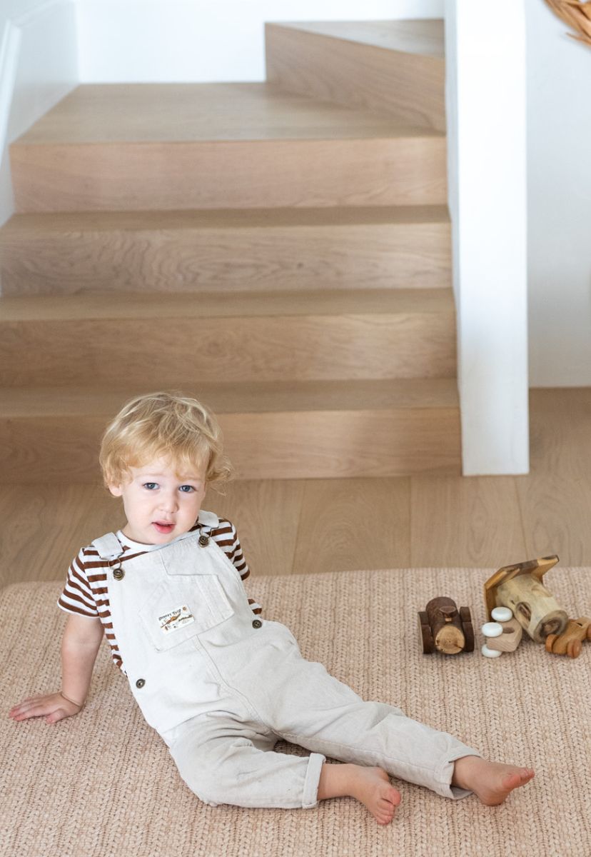 foam padded play mat that looks like a woven knotted rug in neutral colour