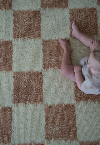 Close up of Rugabub Phoenix checkered non toxic foam baby play mat texture.