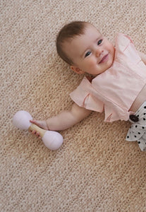 foam padded play mat that looks like a woven knotted rug in neutral colour