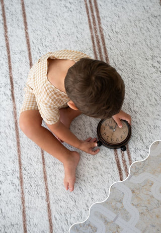 Baby playing on Rugabub Round Cala non toxic foam baby play mat in modern nursery.