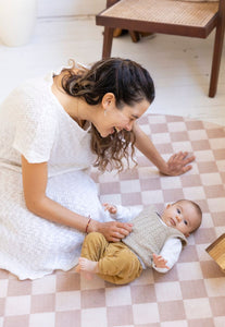 round checkered foam padded baby play mat in latte colour that looks like rug