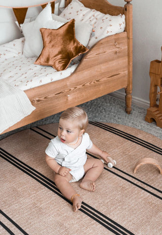 round padded foam baby playmat in neutral colours and black stripes that are waterproof and non-toxic