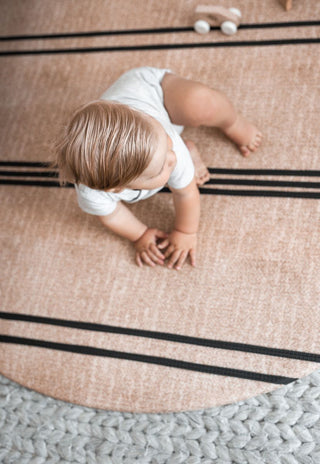 round padded foam baby playmat in neutral colours and black stripes that are waterproof and non-toxic