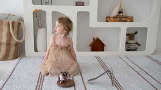 A child playing on a Rugabub TPU foam play mat with Rugaroo swan miniature accessories, Sydney Australia
