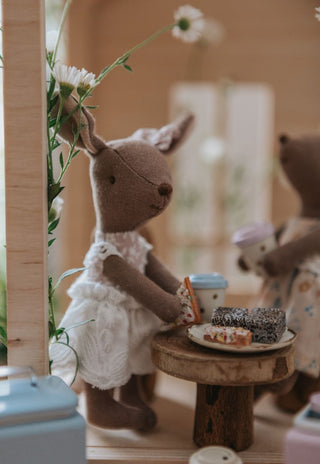 A miniature Rugaroo Kangaroo doll holding  fairy bread, adding a touch of Aussie charm to playtime