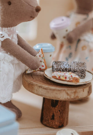 Miniature lamingtons and fairy bread with kangaroo push doll