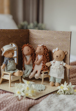 A miniature dollhouse scene featuring four Rugaro Australian echidna and wombat plush dolls.