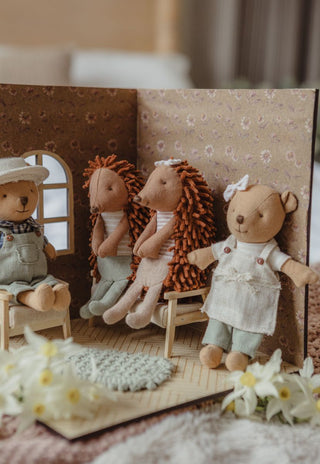 Close-up of Rugaroo Australian character dolls Wazza, Col, Riva and Marg posed in a mini dollhouse room