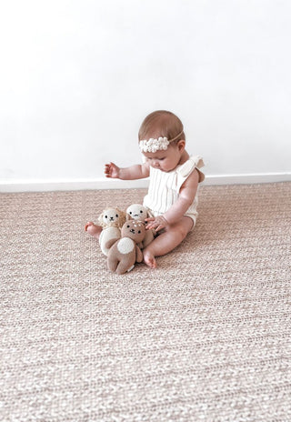 double sided baby foam padded play mat that looks like a woven knotted rug in neutral colour