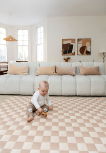 Neutral checkered double-sided foam padded play mat that looks like rug and is waterproof