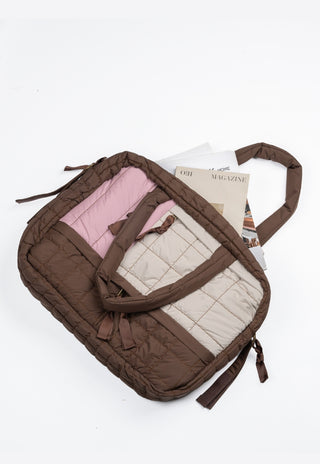 Brown quilted baby nappy bag with pink and beige interior on a white background