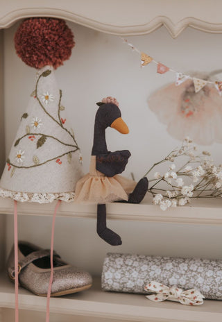 Wattle the Rugaroo black swan plush doll styled on a vintage nursery shelf with dried flowers and bunting - collectible Australian miniature toy for children's room decor